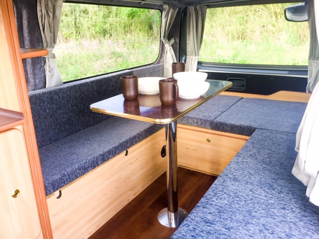 Nissan Nova campervan inside table with cups and plates