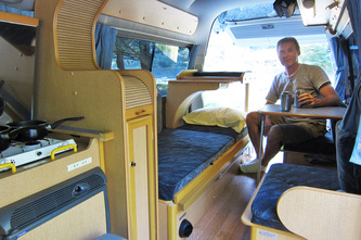 Andre sitting inside nissan caravan camper