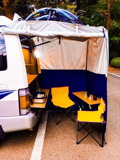 Mazda Bongo campervan under tent