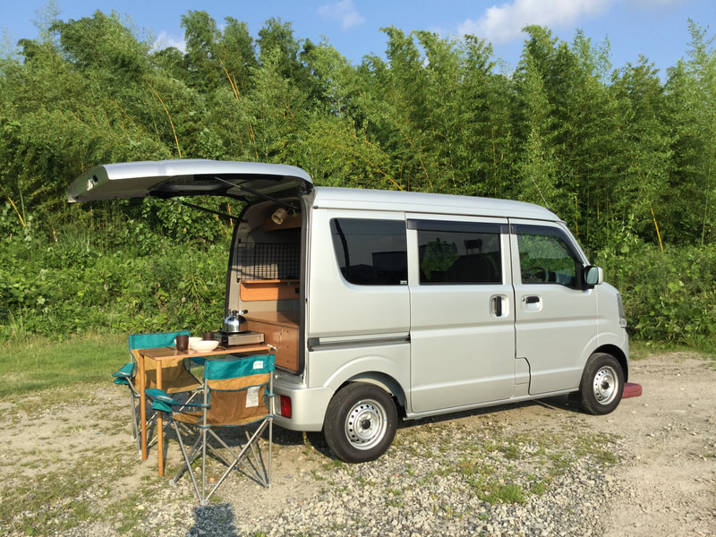 Wink campervan with an outside table, chairs and kitchen set